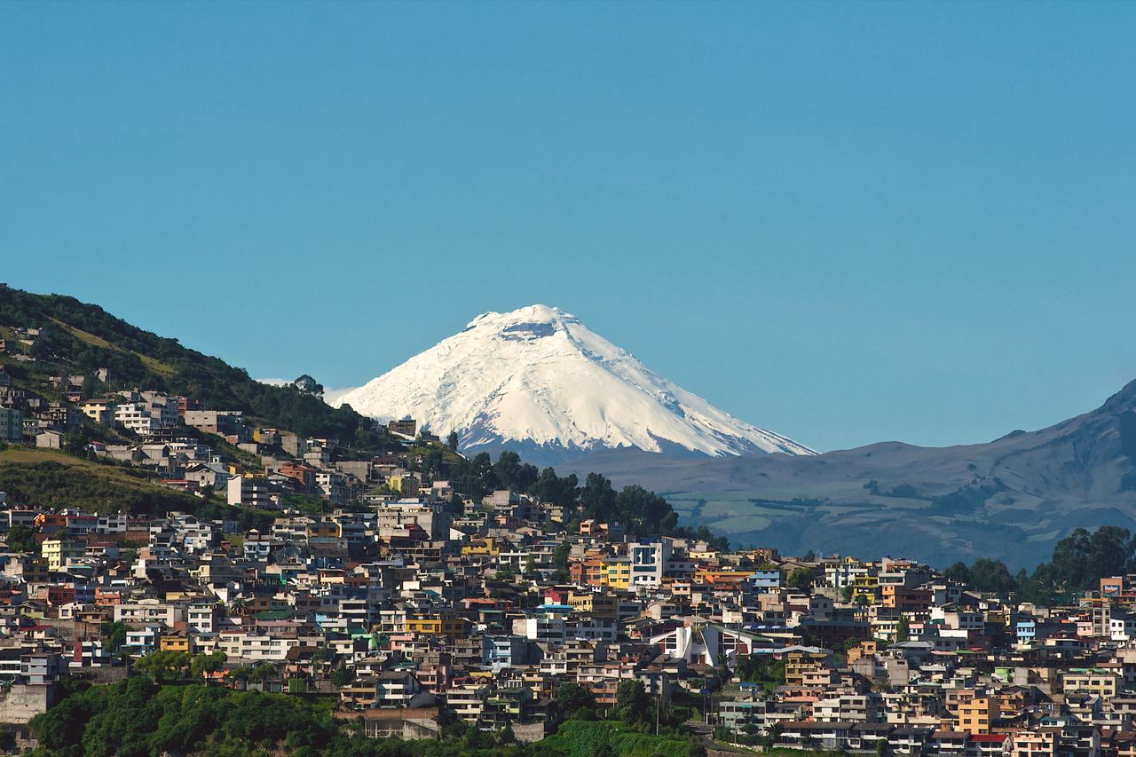 Vue de Quito avec le volcan Cotopaxi illustrant l’assurance vie pour expatrié français en Équateur